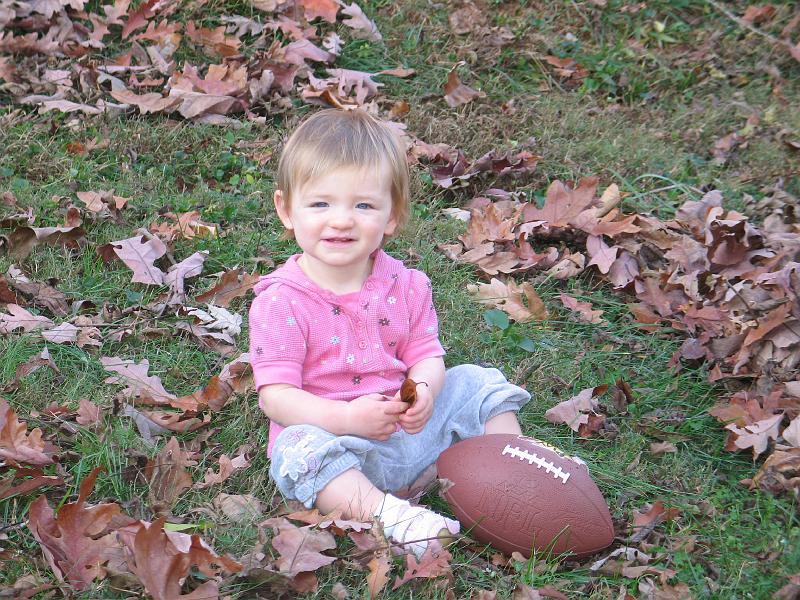 IMG_5956.JPG - madeline playing football in the leaves